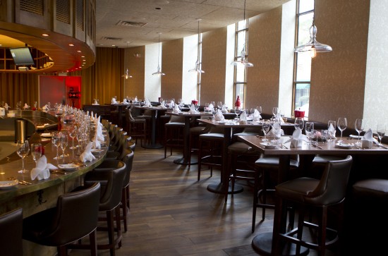 Interior Artisans restaurant looking toward seating facing open kitchen.